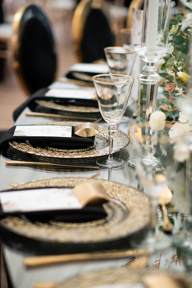 Black glass embroidered with gold charger plates